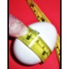 This Chicken Egg's Circumference is Being Measured With a Flexible Metric Measuring Tape The egg's circumference measurement in centimeters is measured with a flexible metric measuring tape.