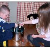 Kids are making playdough in a large cooking pot.