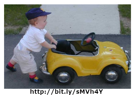 The child is applying an unbalanced force to the car resulting in moving the car.