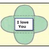 A stick-on label with a message is placed in the center of a paper flower.